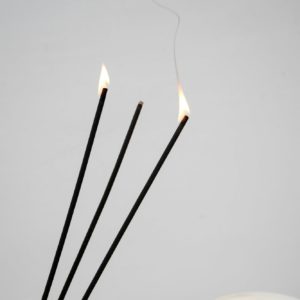 Incense sticks burning with smoke.
